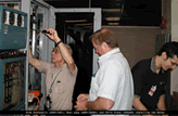 L-Net and DRAGON reps readying the rack space at GSFC where the Movaz RAYexpress unit is to be mounted